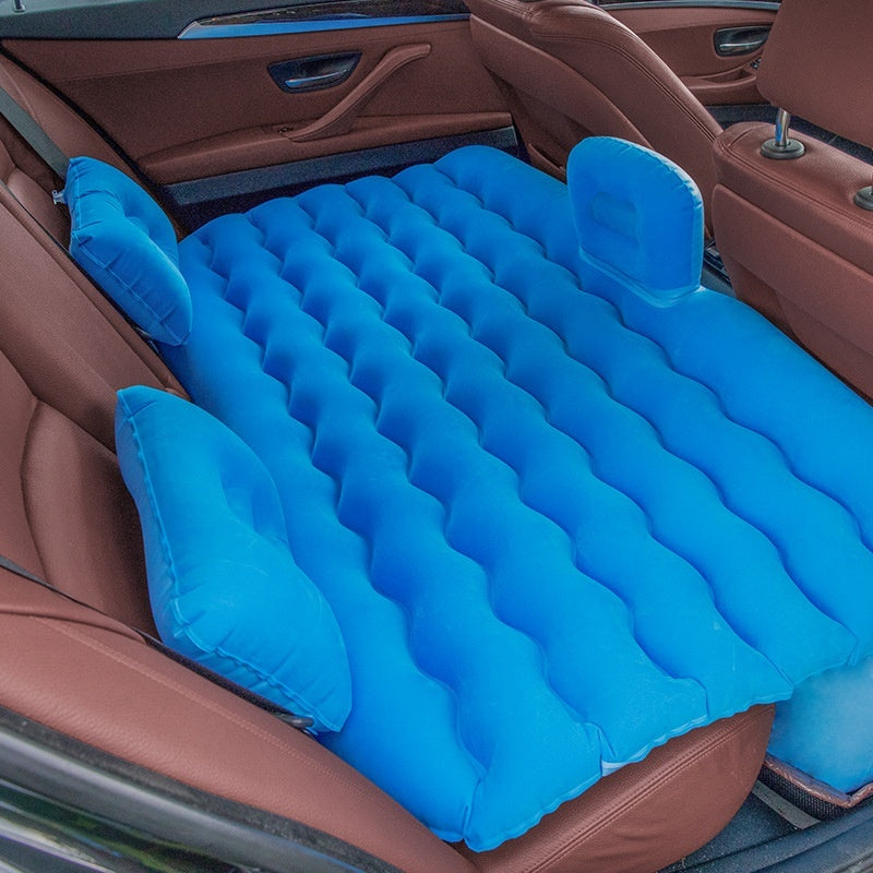 Wave-Shaped Inflatable Car Bed for Travel in a car with blue inflatable pillows and mattress.