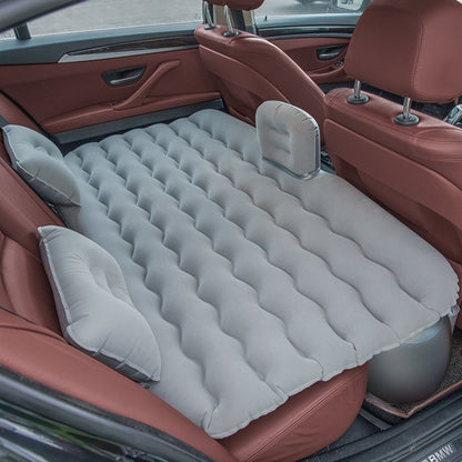Wave-Shaped Inflatable Car Bed shown inflated in a vehicle's backseat for travel comfort.