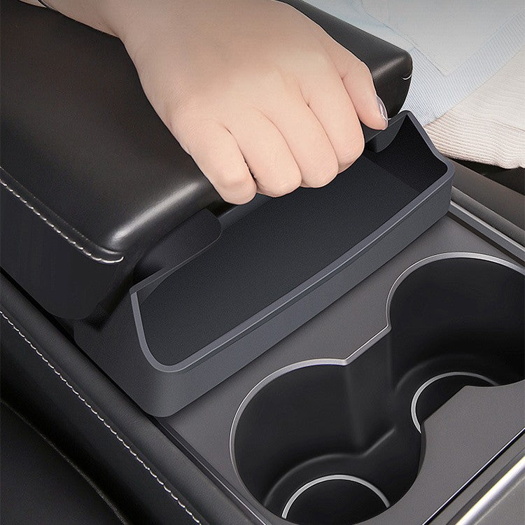 A hand opening a Car Glasses Case in a car's center console, showcasing stylish and practical eyewear storage.